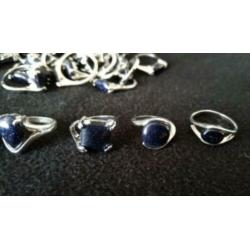 Lot verzilverde dames ringen met blauwe goudsteen 37 stuks.